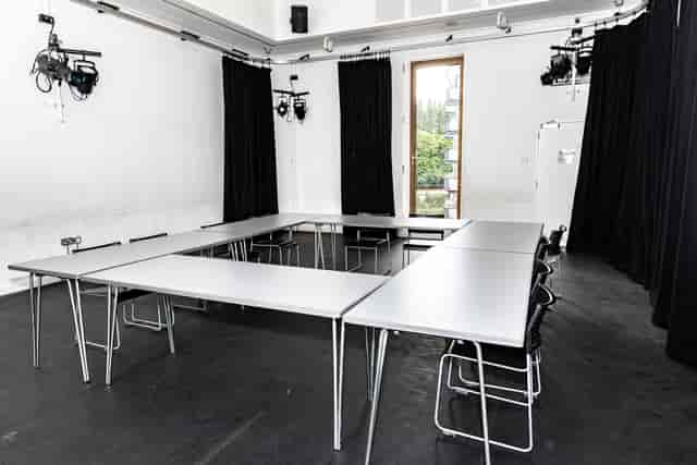 Versatile meeting space in Rose Theatre with a rectangular table for workshops and brainstorming.