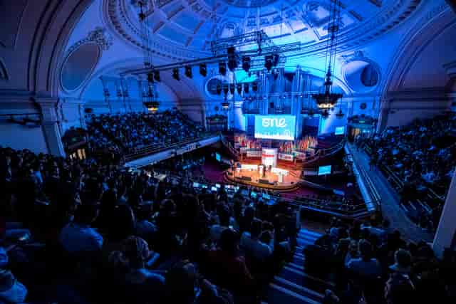 Great Hall Westminster auditorium with blue lighting for impactful conferences and presentations.