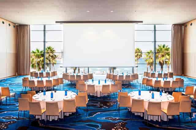 Great Room at W BARCELONA with round tables, ideal for banquets and conferences.