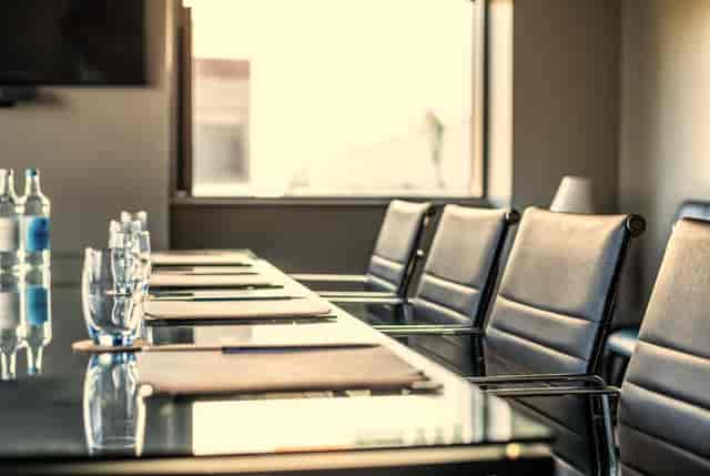 Modern conference room at Guildford Harbour Hotel with glass table setup for meetings.