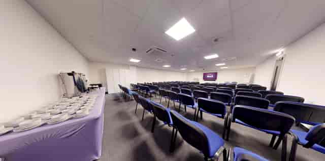 Meeting Room at Gravity Max with blue chairs, ideal for presentations and workshops.