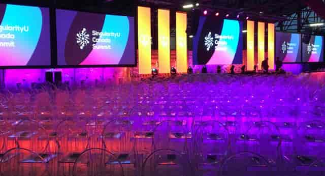 CRH Gallery event space with modern acrylic chairs for a vibrant summit setup.
