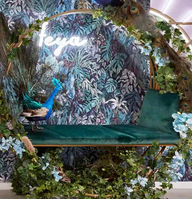 Tropical event backdrop with peacock and lush foliage at Feya Knightsbridge.