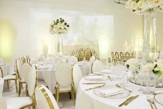Elegant event space with round tables, ideal for weddings and corporate galas.