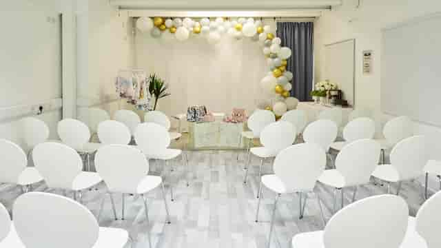 S3 Royal Arsenal event space with elegant balloon arch and modern seating arrangement.