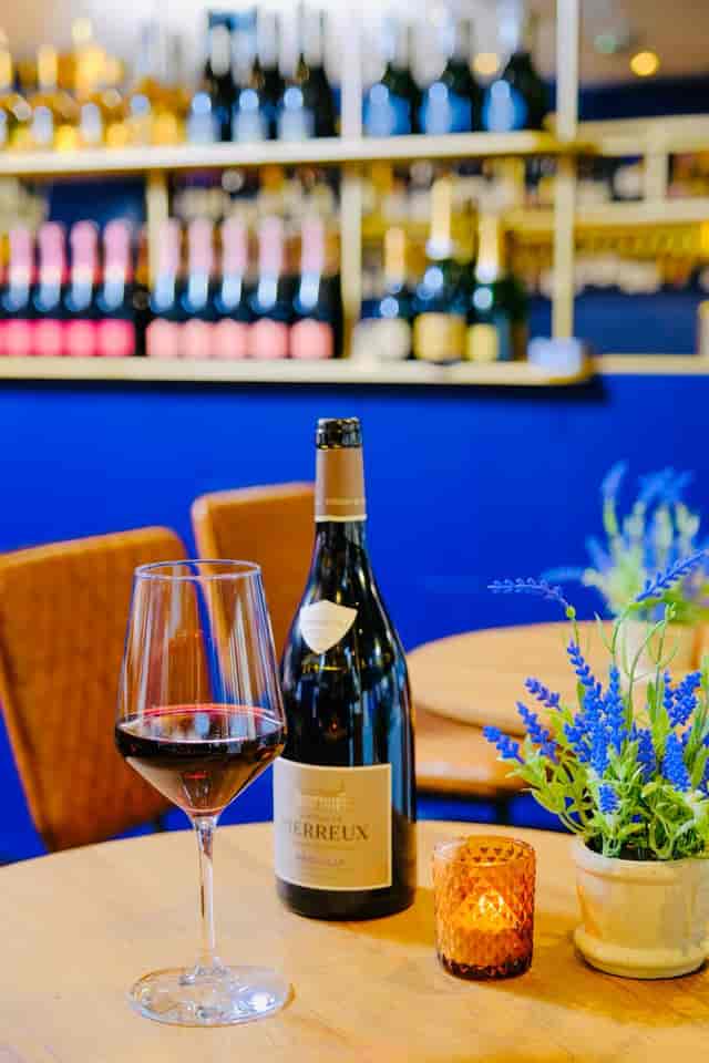 Elegant venue at Voila! Wine Bar, ideal for networking events with wine and floral decor.