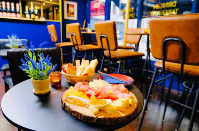 Vibrant Voila! Wine Bar venue with cheese platter, ideal for networking events.