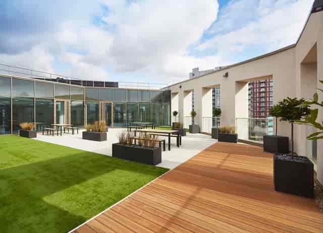 Versatile outdoor event space with greenery and modern design for receptions and networking.