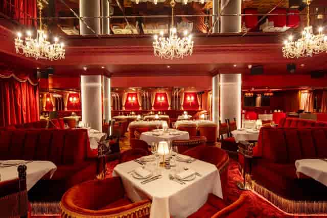 Elegant dining venue with rich red decor, perfect for upscale events and intimate gatherings.