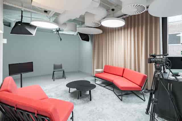 Modern meeting space in Spotlight London with vibrant red seating for events.