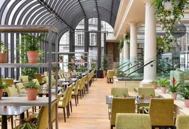 Modern event space with glass atrium, ideal for meetings and upscale events.