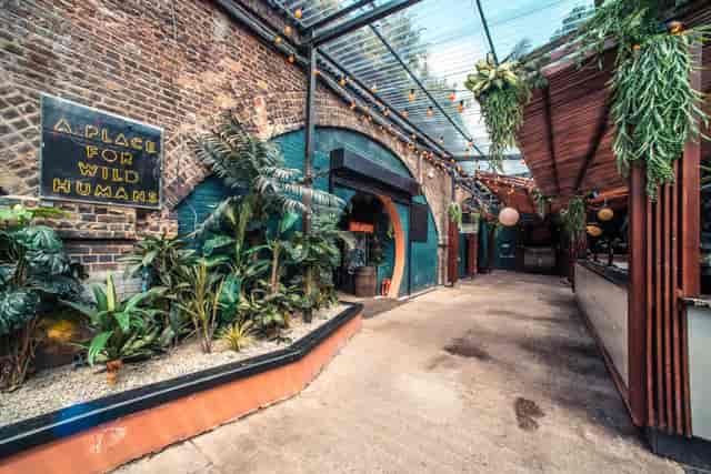 Vibrant garden venue with lush greenery for creative events and gatherings.