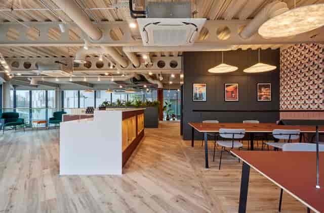Modern meeting room with pendant lighting, ideal for networking events and small meetings.