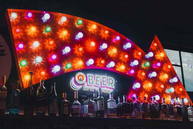 Retro marquee sign at Flat Iron Square beverage station for corporate event branding.