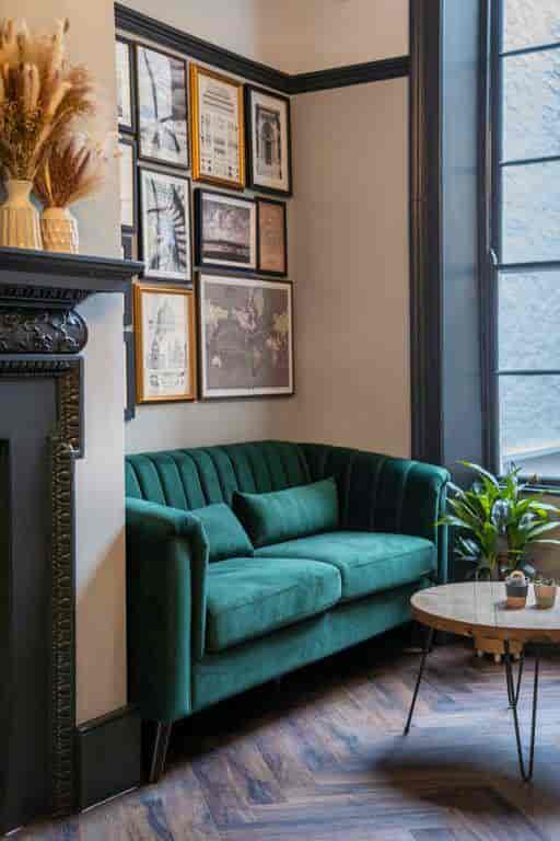 Stylish Members Lounge with plush green sofa, ideal for networking events and meetings.