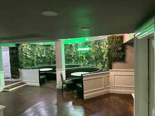 Stylish event space at The Calabash Restaurant with lush greenery and circular seating.