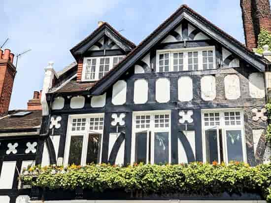 Charming historic bar with black and white facade, ideal for events and gatherings.