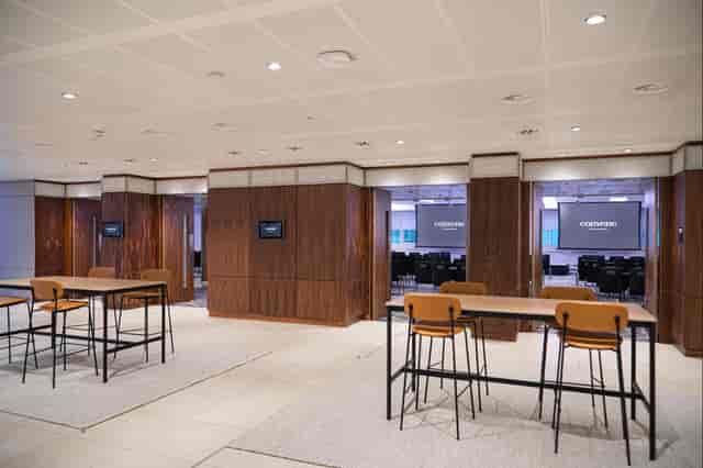 Versatile meeting space with modern furniture for corporate events and workshops.