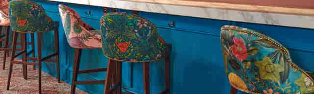 Vibrant 1871 Bar at Royal Albert Hall with unique stools, ideal for networking events.