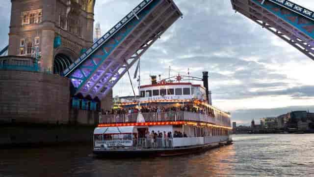 Private boat under Tower Bridge, perfect for corporate events and celebrations in London.