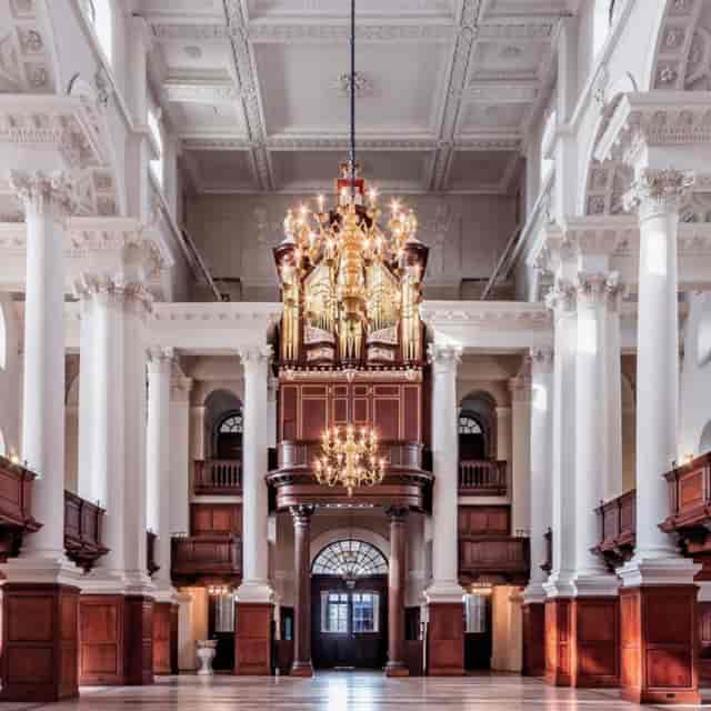 Stunning chapel venue with ornate organ, ideal for formal events and concerts.