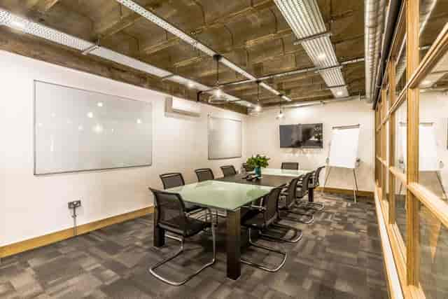 Modern meeting room in Hackney Venues with glass table for productive sessions.