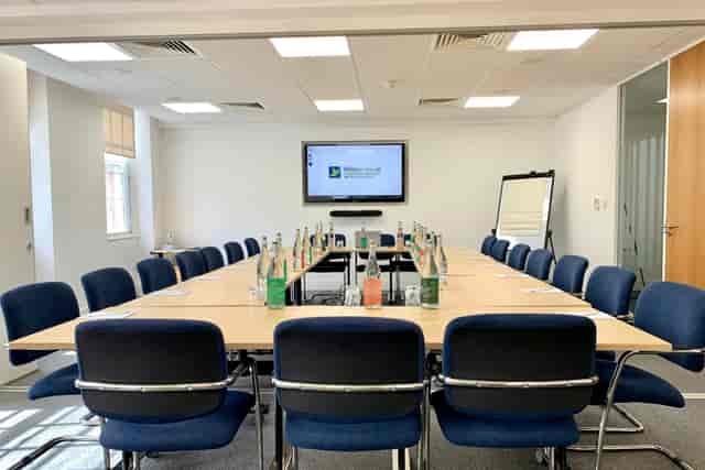 Brunswick Room at Woburn House: spacious meeting room with large table, ideal for conferences.