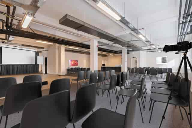 Versatile event space with black chairs for presentations at Baltic St W, ideal for conferences.