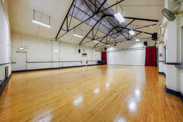Spacious Main Hall in PowerHaus with polished floors, ideal for events and presentations.