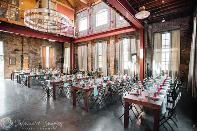 Elegant event space with long tables, ideal for weddings and corporate gatherings.