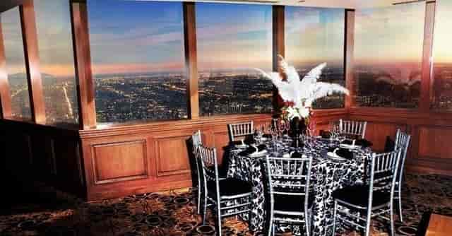 Elegant dining table at Pacific View Tower with city skyline, perfect for upscale events.