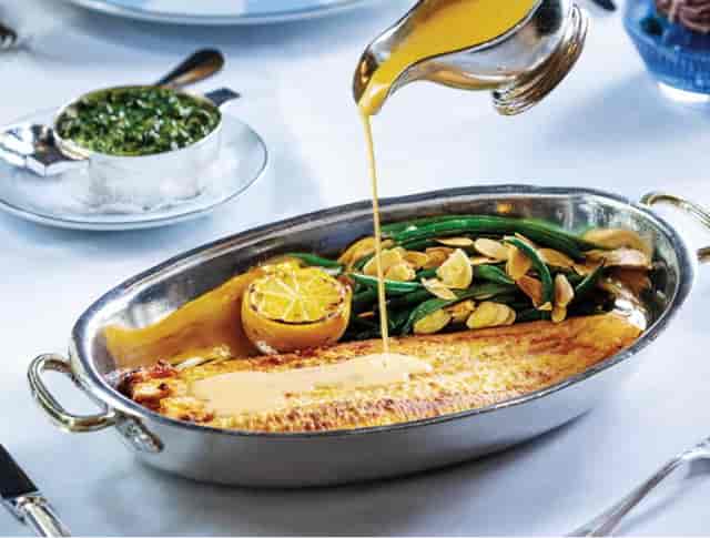 Elegant fish dish on private outdoor patio, perfect for upscale events and corporate dinners.