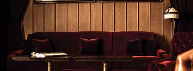 Stylish NoMad Bar lounge with dark wood paneling, ideal for networking events.