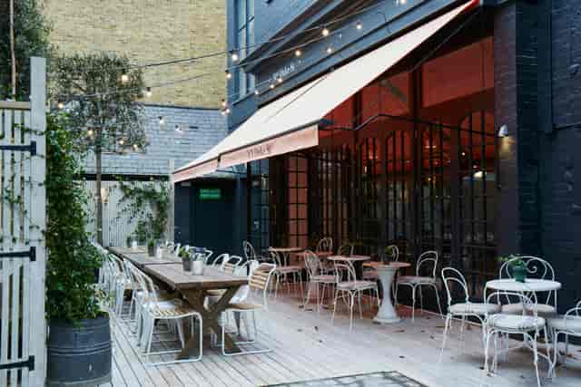 Private dining room patio with string lights, ideal for events and gatherings.