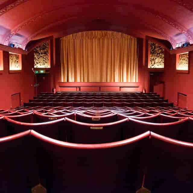 Classic Genesis Cinema theater with red decor, ideal for film screenings and presentations.
