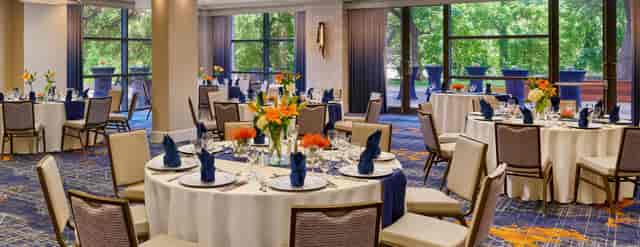 Elegant Capitol Ballroom E with round tables, ideal for meetings and banquets in Austin.