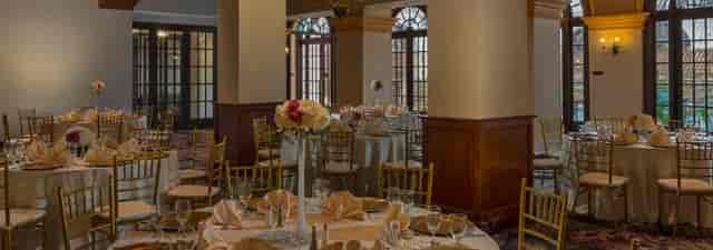 Elegant banquet room with floral centerpieces for weddings and corporate events.