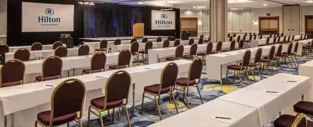 Corporate meeting space at Hilton Austin Airport with organized tables and chairs.