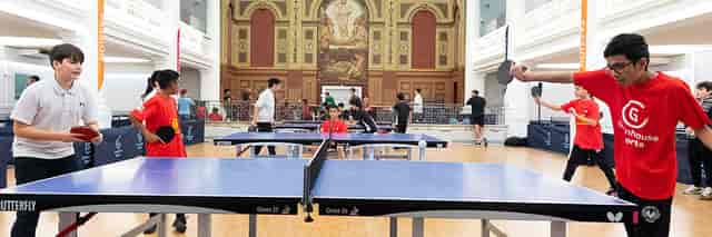 Table tennis event at The Harrow Club with vibrant participants and elegant decor.