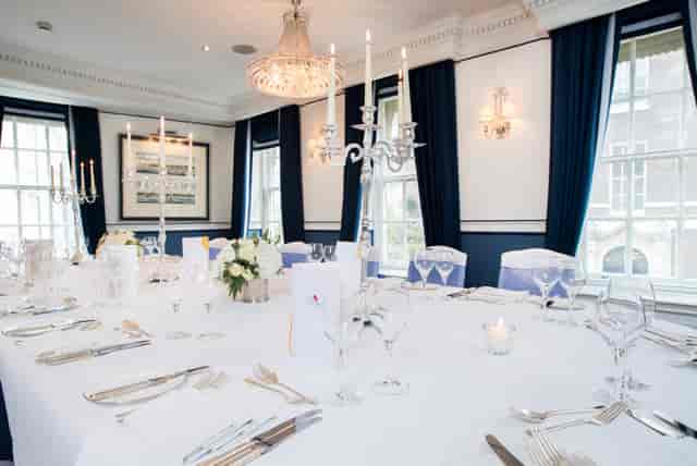 Queen Suite dining table with candelabras, ideal for corporate dinners and events.