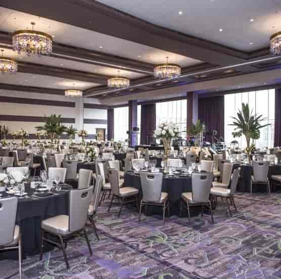 Elegant event space with black linens and white flowers, perfect for weddings or corporate events.