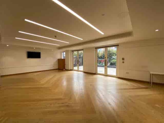 Upper Hall event space at Alpha Grove with natural light for conferences and receptions.