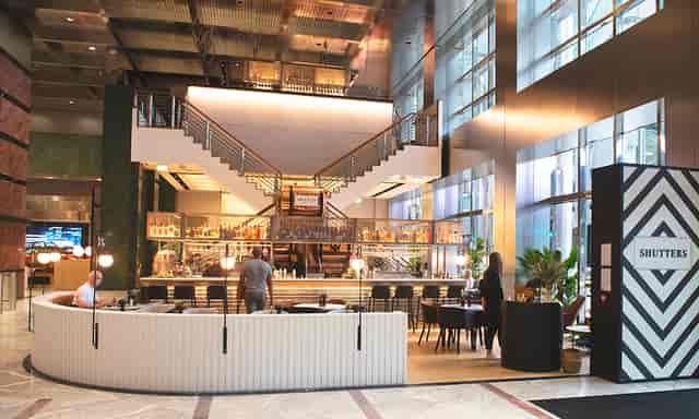 Modern event venue with elegant staircase, ideal for meetings and networking at Canary Wharf.