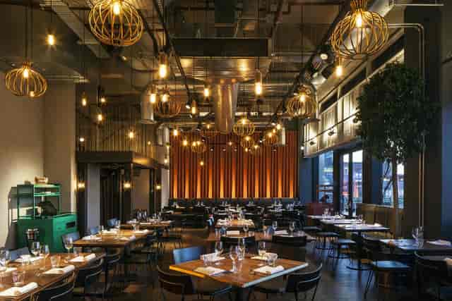 Stylish restaurant dining room with warm lighting, ideal for events and gatherings.