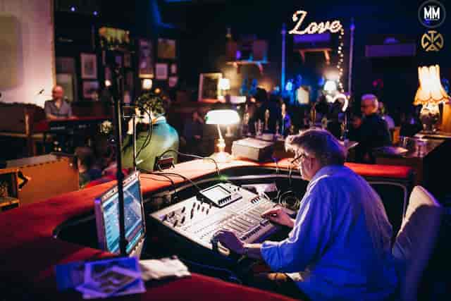 Sound engineer managing audio at TAM's Vineyard for a vibrant live music event.