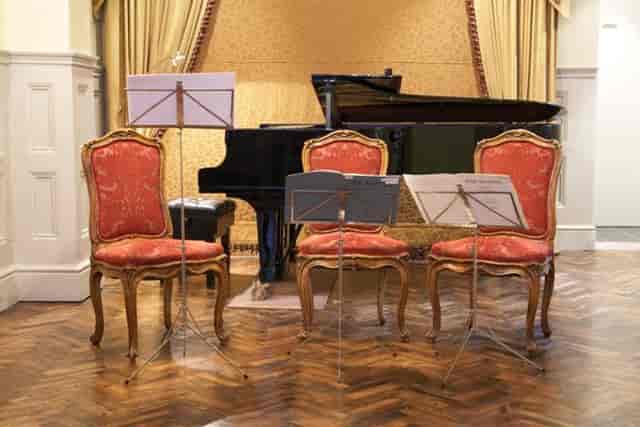 Elegant musical setup with ornate chairs at 1901 Arts Club for intimate events.