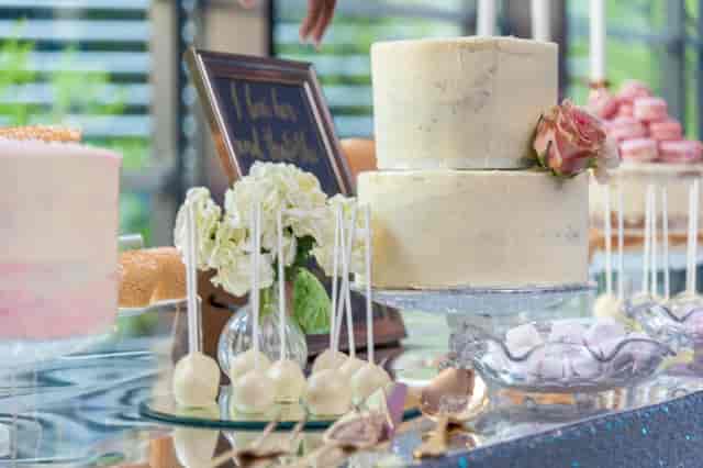 Elegant dessert table with two-tiered cake at Hilton London Tower Bridge for weddings.