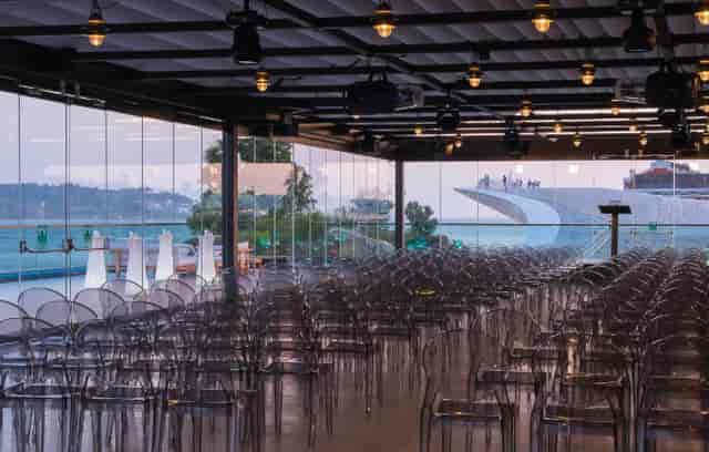 Modern Lisboa Hall event space with acrylic chairs and scenic views for conferences.