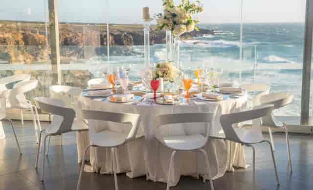 Elegant dining table with ocean view at Oceano Room, ideal for upscale events.