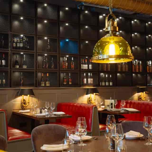 Stylish Kibele Restaurant interior with red booths, perfect for corporate dinners and gatherings.